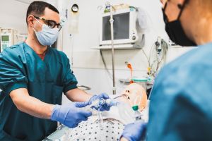 Students at a nursing doll in the health care simulation learning environment.