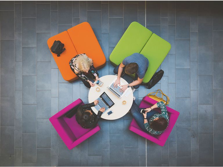 Students sitting around a table.