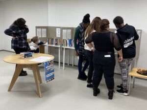 The students are planning the book spine poetry from the names of the books.