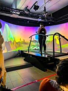 A student is standing on a treadmill.