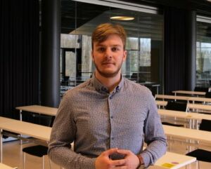 A student stands in a classroom.