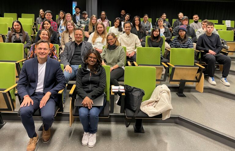 / A group of people sitting in an auditorium for a portrait picture.