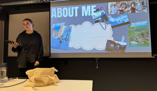 A person standing in front of the classroom and showing a presentation.