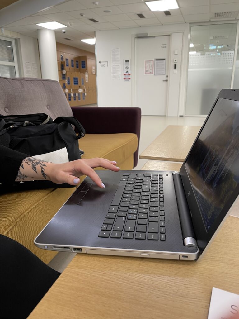 A person's hand using a laptop.