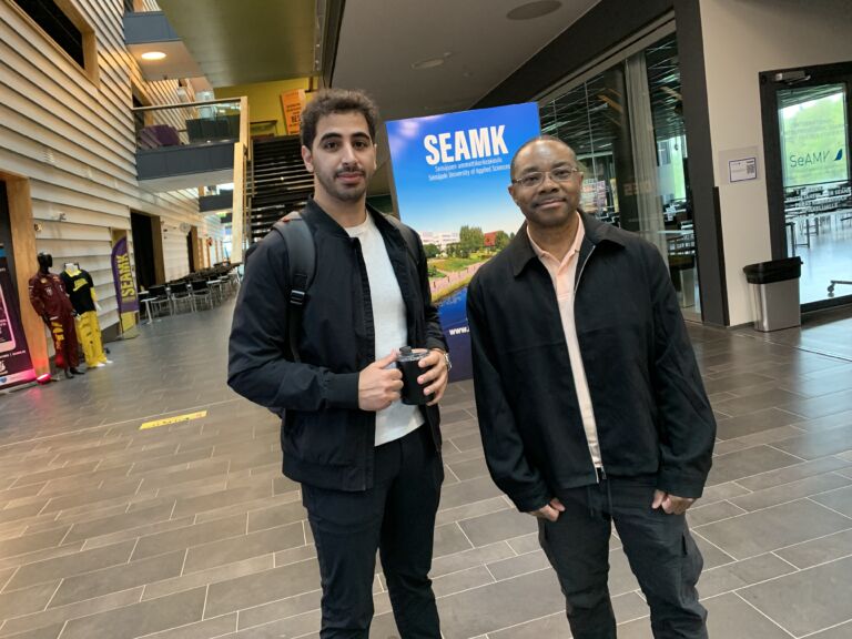 Two male students in university lobby