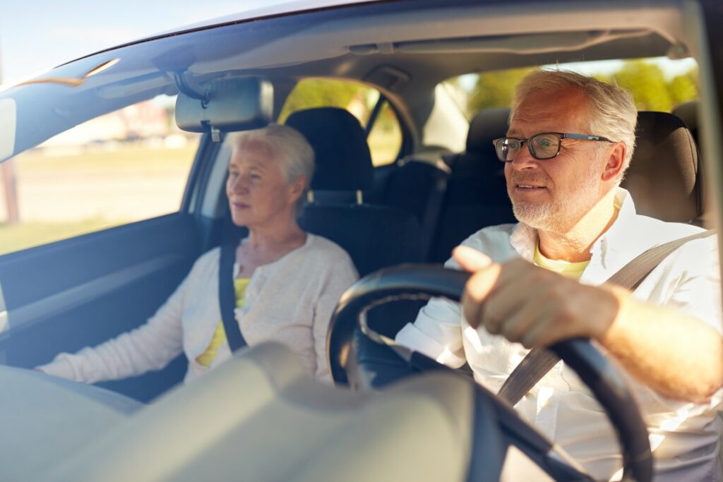 senior man and woman driving