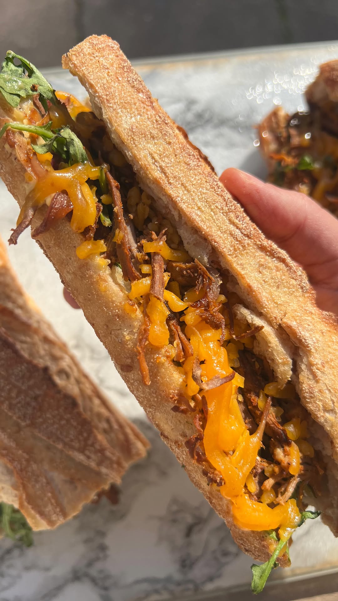Gratinated Pulled Lamb, Cheddar and Caramelized Onion Sandwich