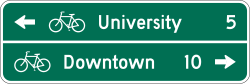 Two line bicycle destination guide sign with distance