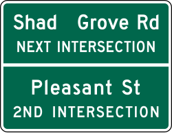 Advance street name guide sign with 4 lines of information