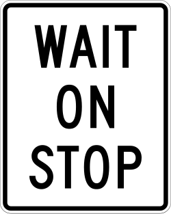Instructs drivers to wait when stop indication is displayed