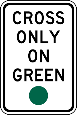 Instructs pedestrians to cross only when the signal shows green