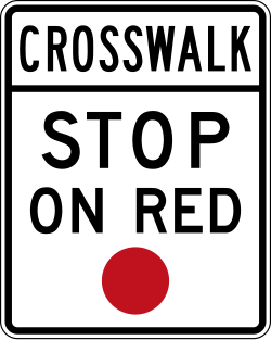 Requires stopping at crosswalk when signal is red