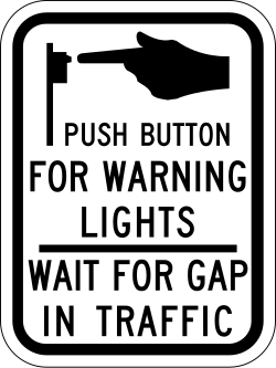 Instructions to push button for warning lights and wait for traffic gap
