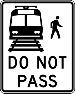 Prohibits passing stopped trains at railroad crossings