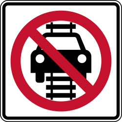 Prohibits vehicles from driving on railroad tracks
