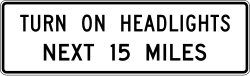 Instructs drivers to turn on headlights for the next specified distance in miles