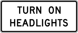 Instructs drivers to turn on their headlights