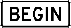 Plaque marking where the two-way left-turn lane begins