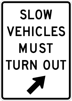 Requires slow vehicles to turn out at this location