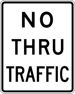 Prohibits vehicles from using the road as a through route