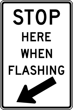 Requires drivers to stop at this location when signal is flashing