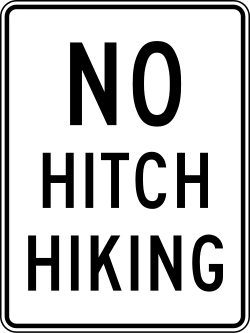 Prohibits hitchhiking with text-based sign