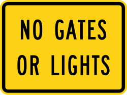Supplemental plaque indicating no gates or lights at crossing