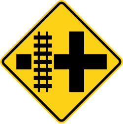 Crossroads with railroad tracks parallel to the left
