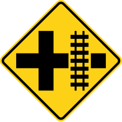 Crossroads with railroad tracks parallel to the right