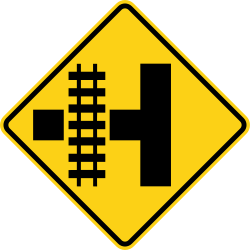 Side road with railroad tracks parallel to the left