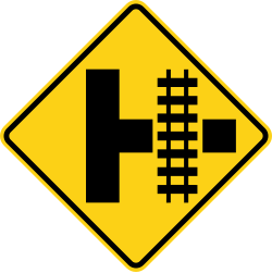 Side road with railroad tracks parallel to the right