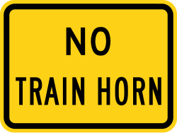 Supplemental plaque for no train horn warning