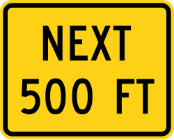Supplemental plaque indicating next distance in feet
