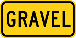Supplemental plaque indicating gravel surface for truck ramp