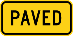 Supplemental plaque indicating paved surface for truck ramp
