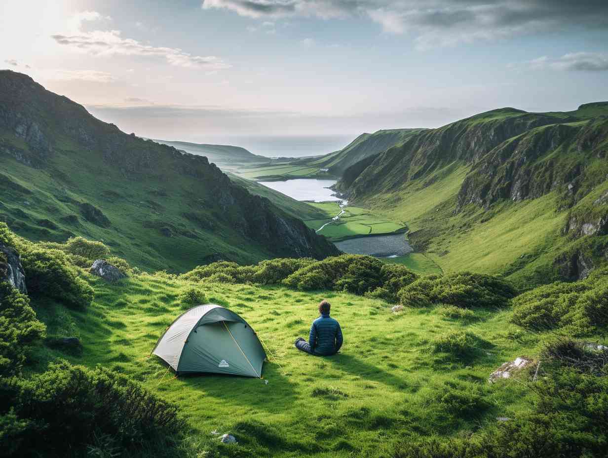 Hiker setting up a tent in stunning Irish landscape