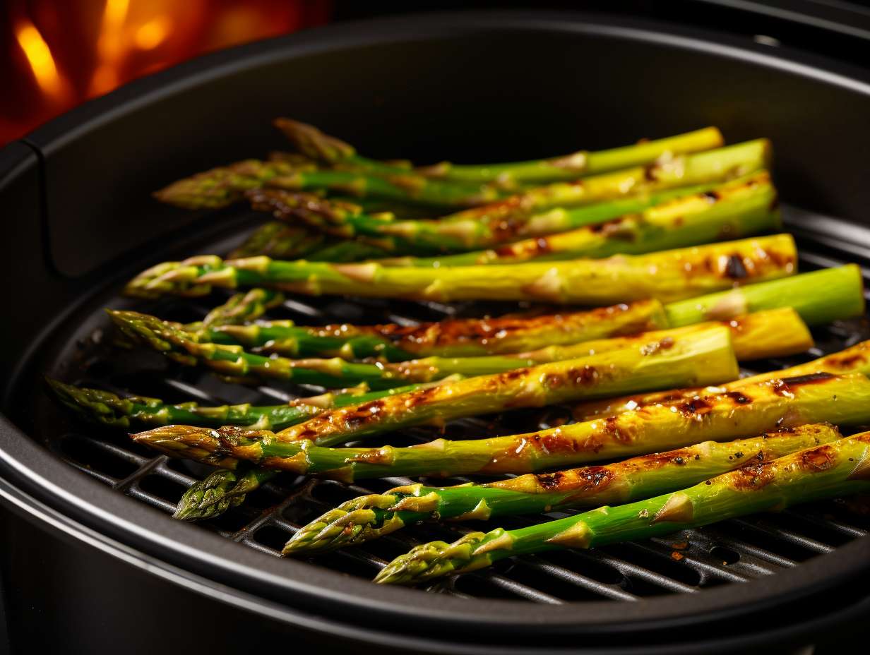 Fresh green asparagus spears arranged in an air fryer basket, seasoned and crisped to perfection.