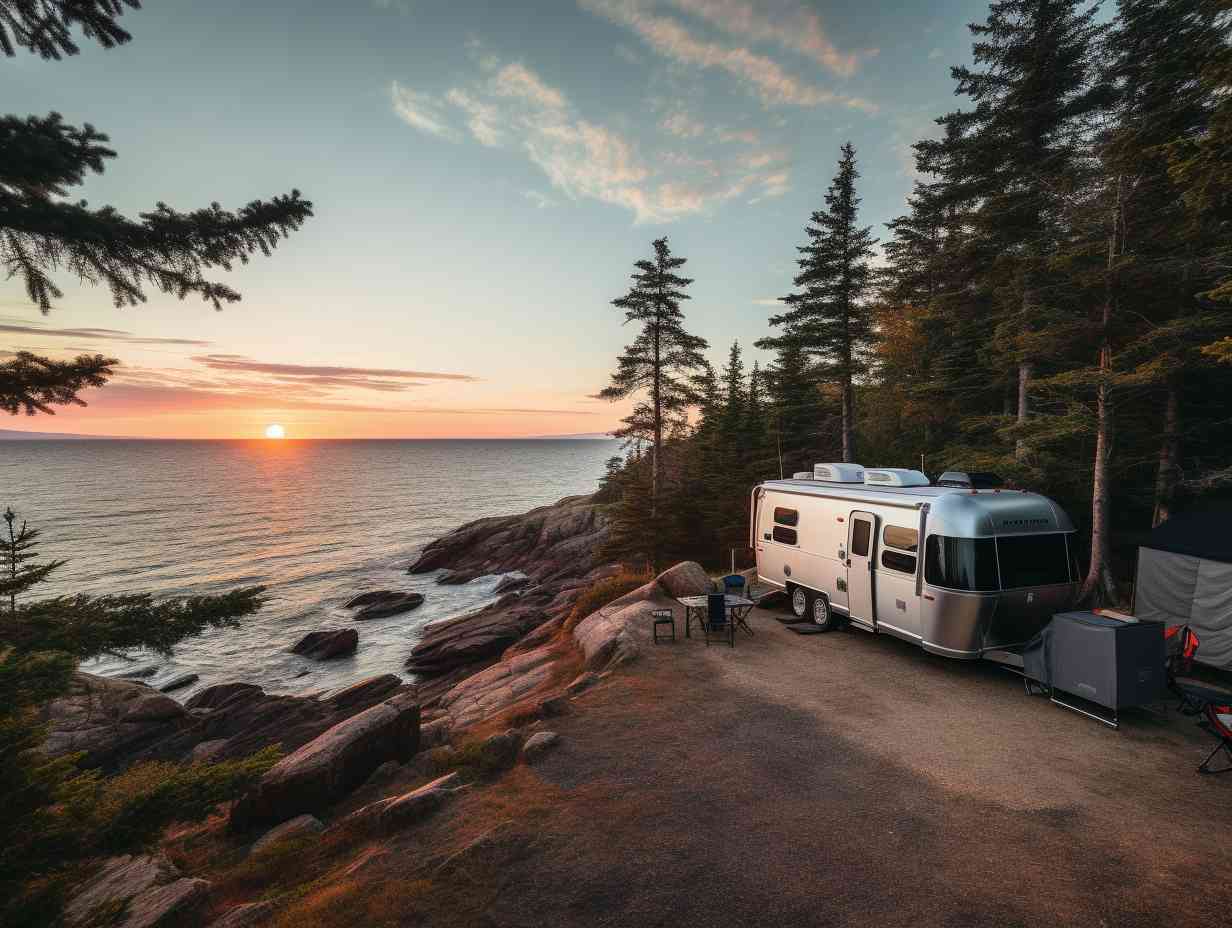 A stunning campsite nestled in pine trees with an RV overlooking Acadia National Parks coastline and the Bass Harbor Lighthouse