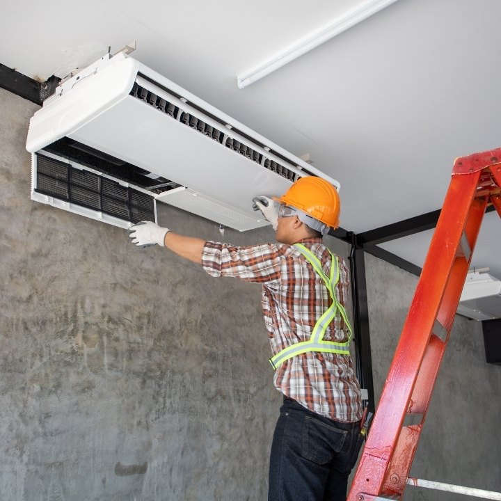 HVAC professional while diagnosing