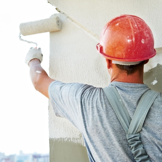 painter painting the house wall