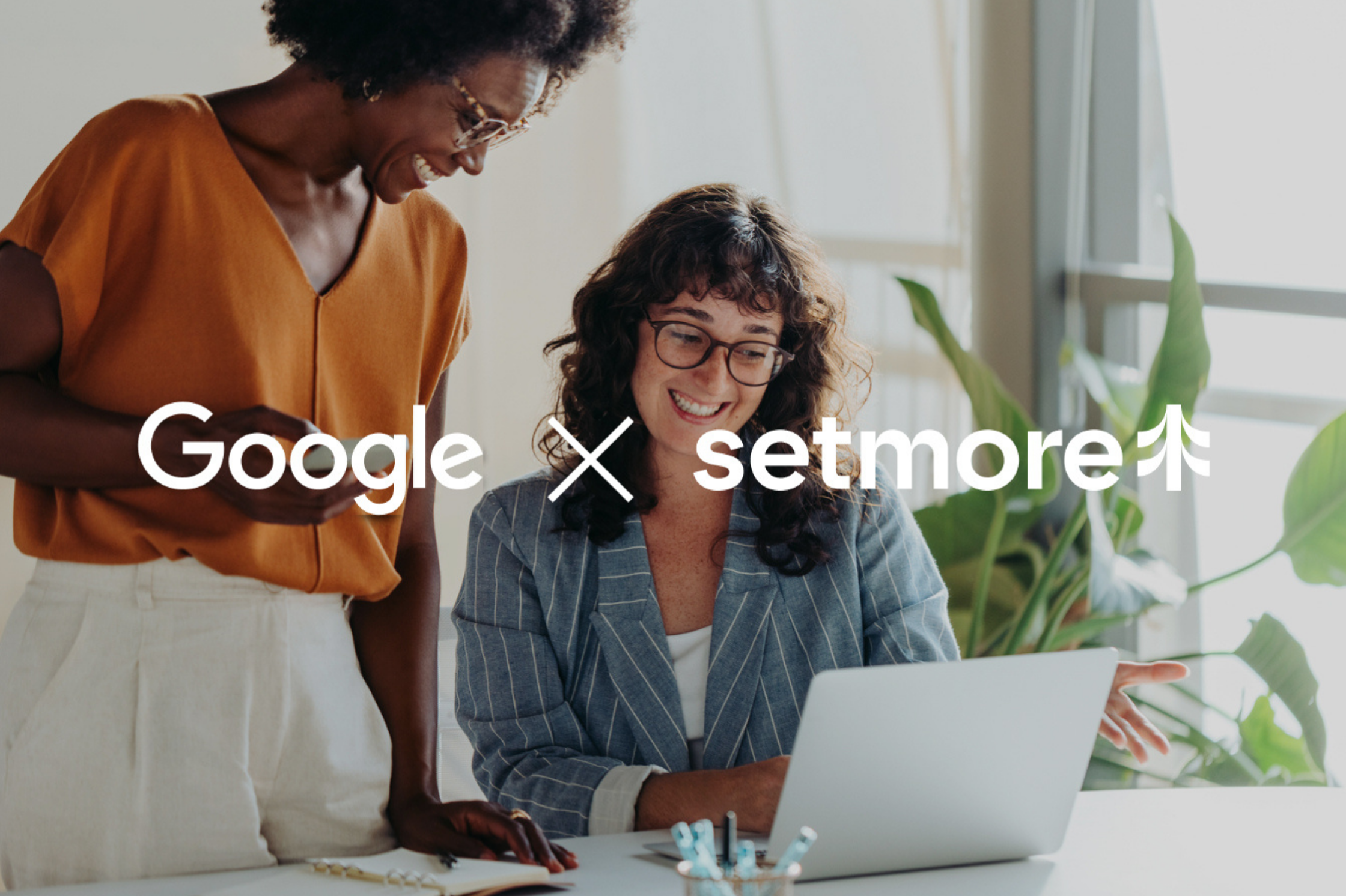two women in background, looking at laptop, in foreground Google X Setmore is center