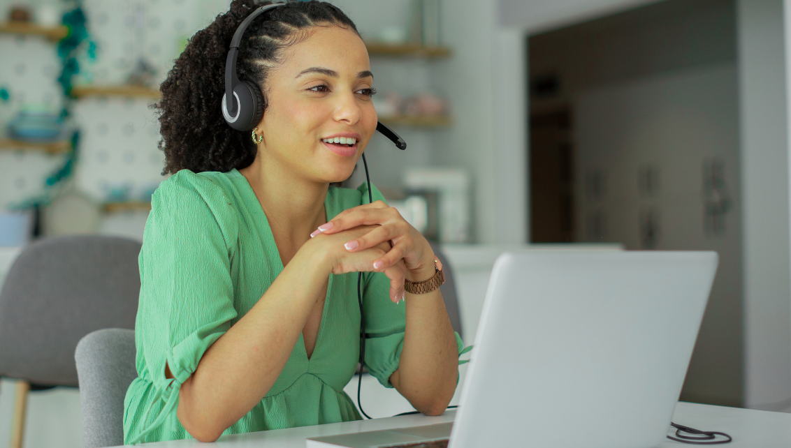 woman in green top speaking on headset