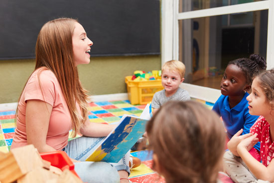 Preschool teacher reading to children