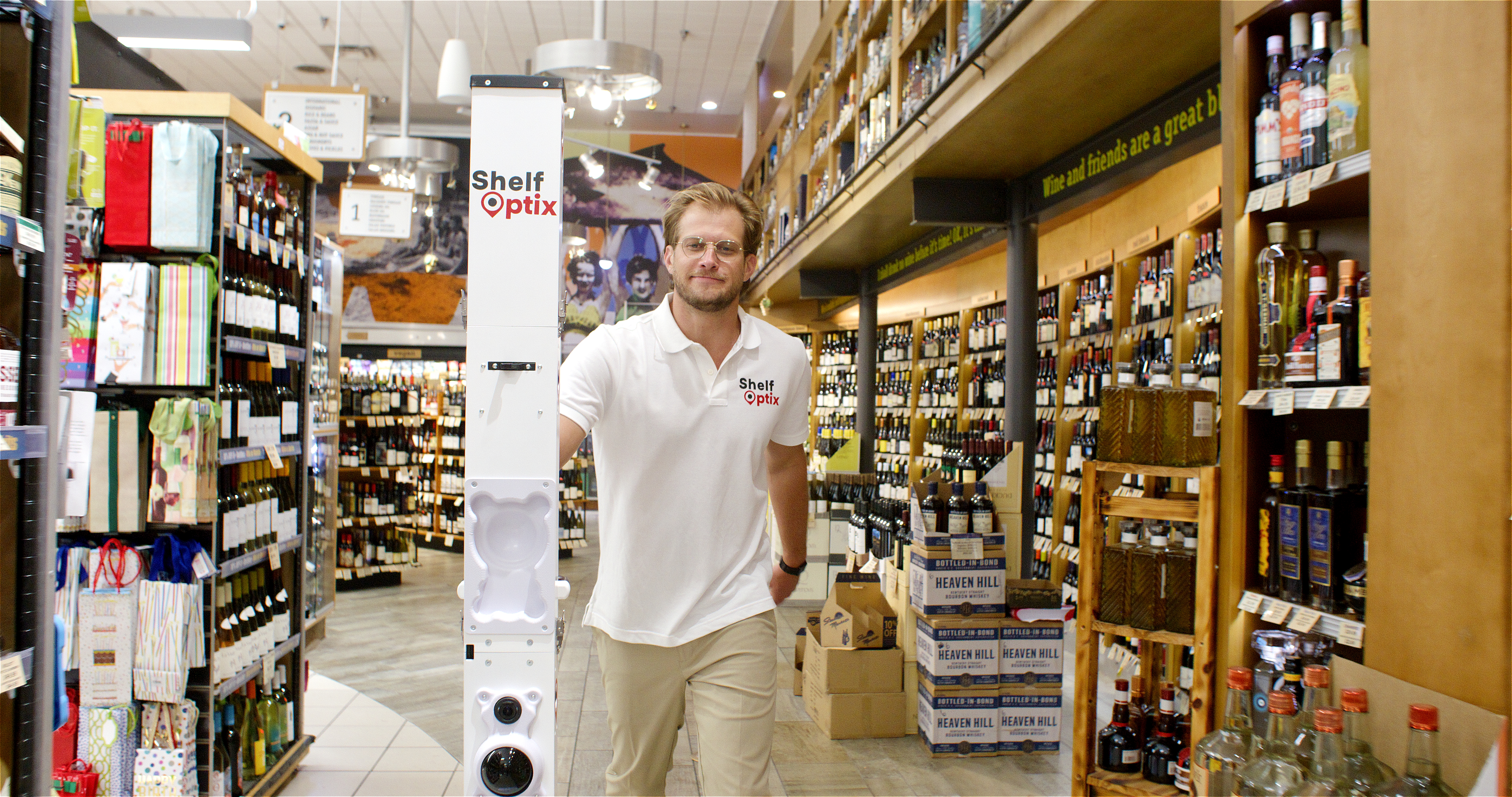 ShelfOptix™ associate deploying robot in store aisle for brand shelf scan