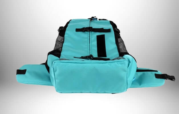 Voici une photo d'un sac a dos transport chien, de couleur turquoise et doté de poches latérales.\n