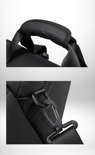 Gros plan sur la poignée et la sangle d'un grand sac sport noir. La poignée est rembourrée et cousue. La sangle d'épaule est attachée au sac avec un mousqueton noir.