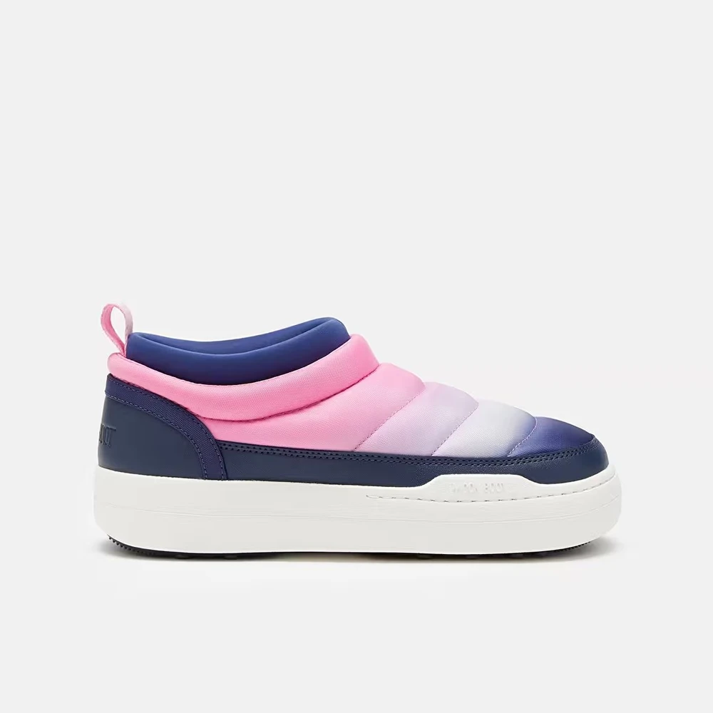 Pink and navy quilted slip-on shoe in side view on a gray background