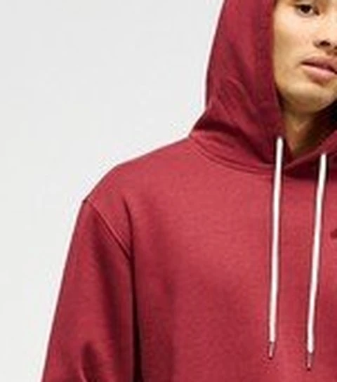 Close crop of the maroon hoodie in the catalog photo with two white drawcords hanging from the hood