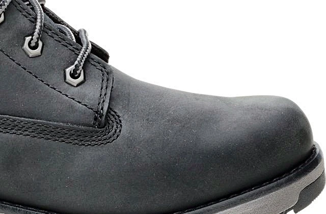 Close-up of the same black leather boot toe with visible leather grain and stitching
