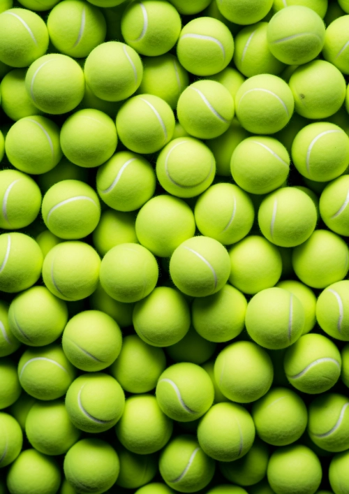 Chewing gum in shape of tennis light green balls, wallpaper long exposure view on many tennis balls, panoramic composition